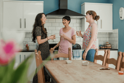 I-Hired-My-Friend-to-Clean-My-House-Three-Women-Standing-and-Talking-in-Kitchen-400×267